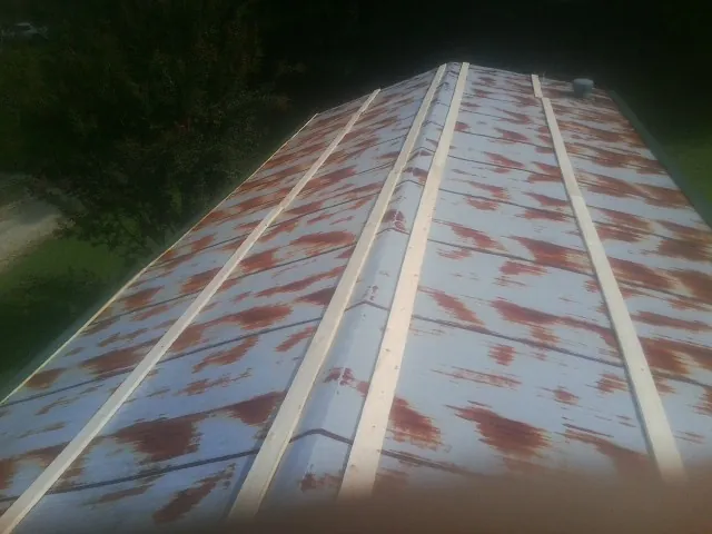 Rusted metal roof panels with new wood purlins before replacement — Storm Damage Roof Repair in Ninety Six by Roofing Brothers